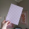 Een vel papier met roze en wit geblokt design, bedoelt voor creatieve projecten zoals junkjournallen of scrapbooken.